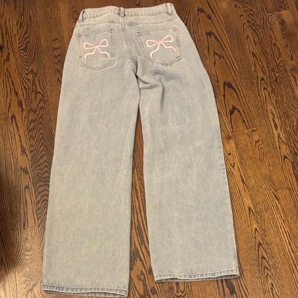 Edikted XS Light Blue Flare Jeans with Pink Bow Detail